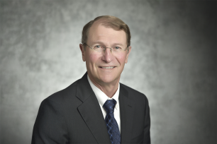 Franklin M. Orr, Jr. in grey suit and blue tie. 