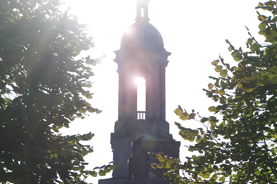 Old Main silhouette with sun flare 