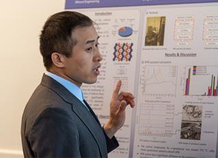 Shihua Han in front of research poster